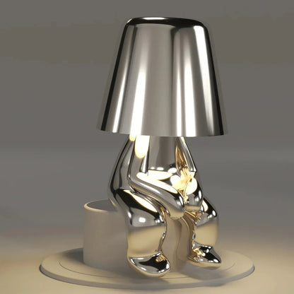 Kabellose Tischlampe mit skulpturalem Figurendesign und warmem Licht